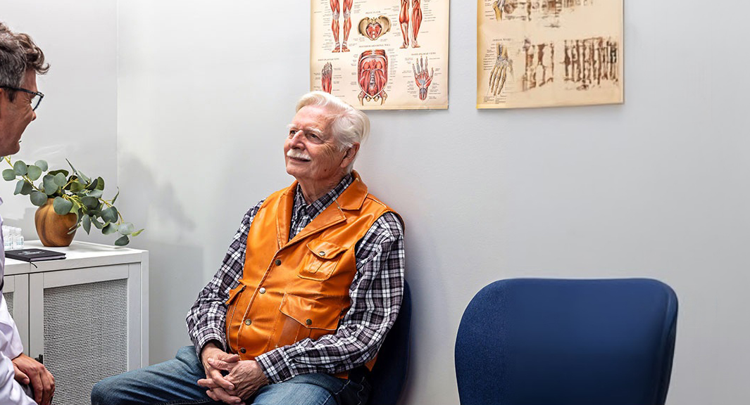 Elderly man speaking with his doctor